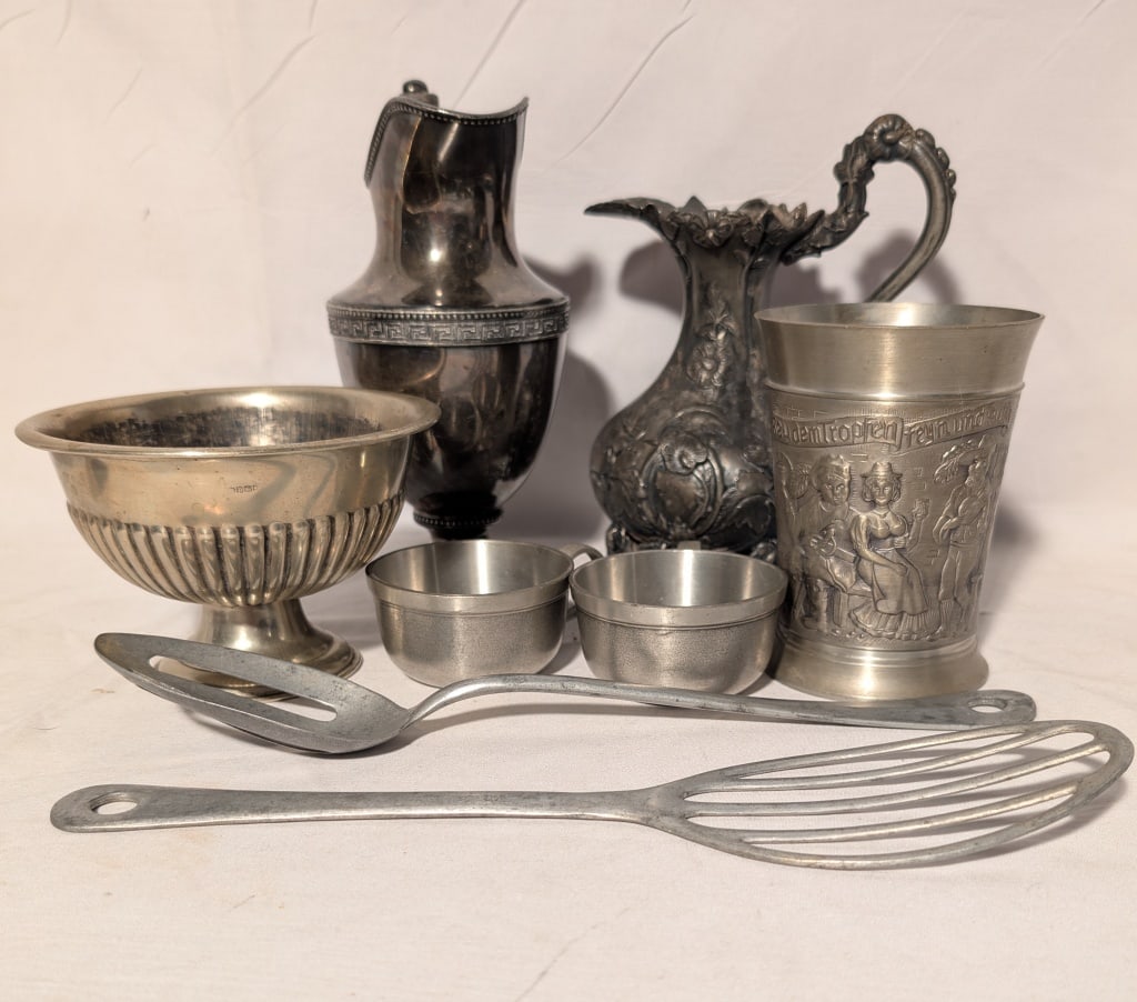 Silverplate and Pewter Collection 7 pcs: Silverplate and Pewter Collection 7 pcs. Tall pitcher by Meriden Brita Co w/ traditional design on pedestal base meas.7"h x 4'w. Victorian design silverplated pitcher B 17 I E 6 October 1766 w ornate