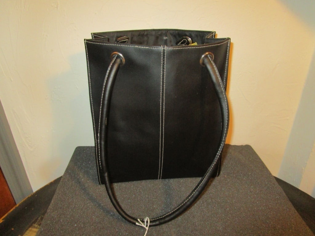 Lillian Vernon Leather Tote Bag: Lillian Vernon Leather Tote Bag . Black leather with white stitching. Chrome accents, no wear. Like new. meas. 11"h x 9 1/2"w. 11" straps. Flat bottom, stands upright. Black interior.