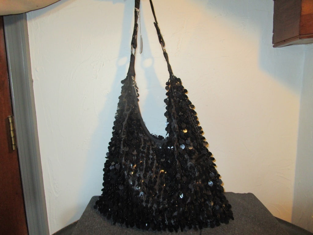 Black Bead/Sequin Shoulder Bag: Black Bead/Sequin Shoulder Bag w/ zipper. Silver/gray liner. Small hole in interior bottom. Some sequins missing but not noticeable. Shoulder strap is adjustable. Meas. 19"h x 13"w x 1/2"d including s