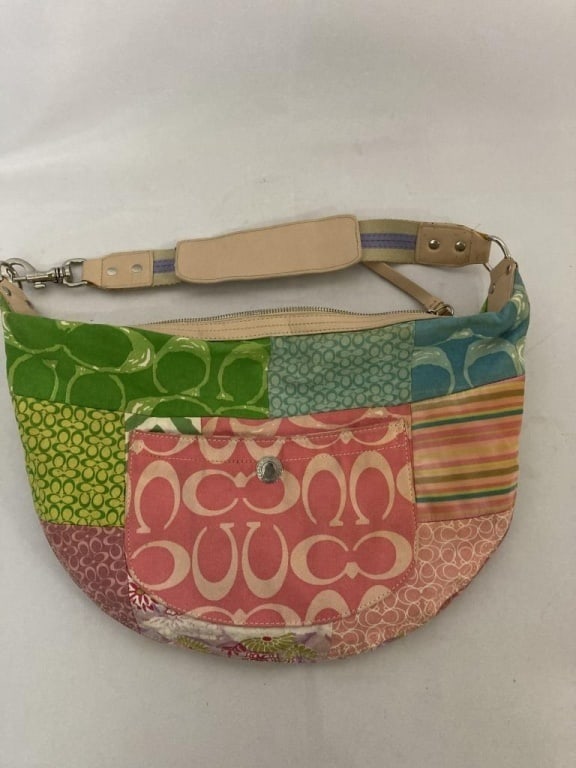 Vtg Coach Multi Logo Colored Hobo Bag: Vtg Coach Multi Logo Colored Hobo Bag. Cloth w/ leather trim and shoulder strap. Chrome accents. Interior is gold logo design w/ original tag. 2 interior pouches and 1 zipped pocket. In tact, no condi