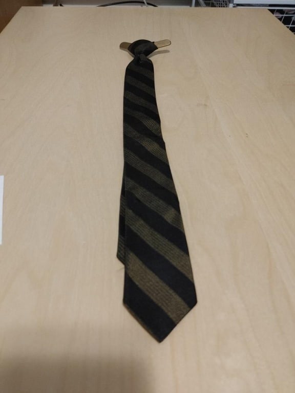 Vtg Boys Necktie - Clip-on, Black/Green Stripe: Vtg Boys Necktie - Clip-on, Black/Green Stripe. Plastic color inserts w/ plastic neck hook. Polyester. Meas. 17"l from top of knot to tip. 3"r at clip. Very nice condition.