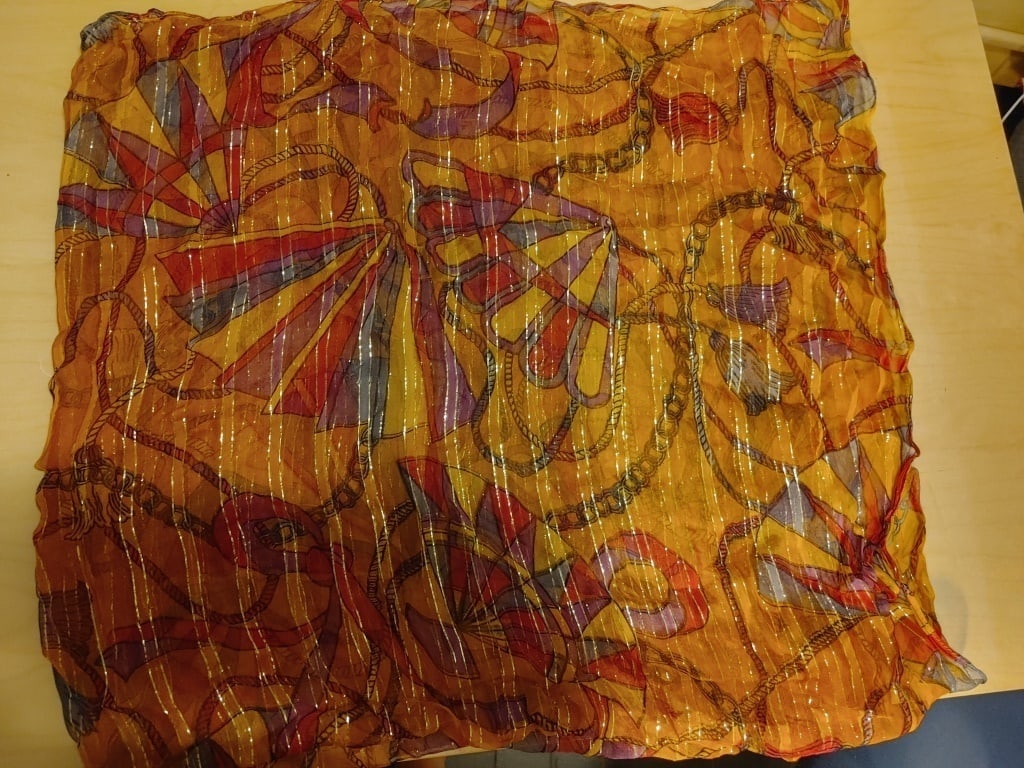 Scarf / Wrap / Pashmina, 100% Rayon India: Scarf / Wrap / Pashmina, 100% Rayon India. Orange, purple, pink & gold thrread. Rope w/ tassle design. Meas 45" x 40". Mint