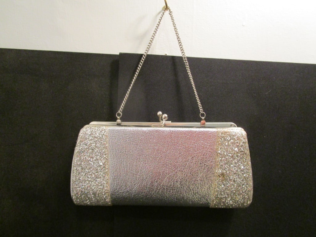 1950s Silver Evening Bag / Clutch: 1950s Silver Evening Bag / Clutch. Exterior silver w/ silver sequins on sides, clasp closure, light being linen interior,. Rectangular in shape, slight indentation on rear, minor staining inside. Meas