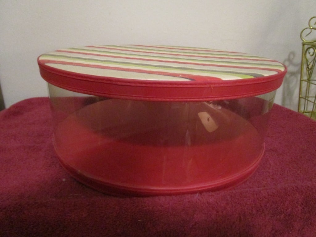 1950s Hat Box, Red/Green/Beige Quilted Striped Lid: c1950s Hat Box - Red/Green/Beige Quilted Striped Lid w/ red translucent plastic base. Cardboard base and top. Discolored due to age. In tact, minor stain on top. Meas 7"h x 17 1/4"r.