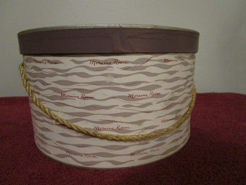 1940s Hat Box, Moraine Room Logo Design: 1940s Hat Box, Moraine Room Logo Design and Distinctly Rikes.. Original rope and tissue paper. Completely in tact. All cardboard. Side design, continued on bottom. MInor discoloration. Completely in t