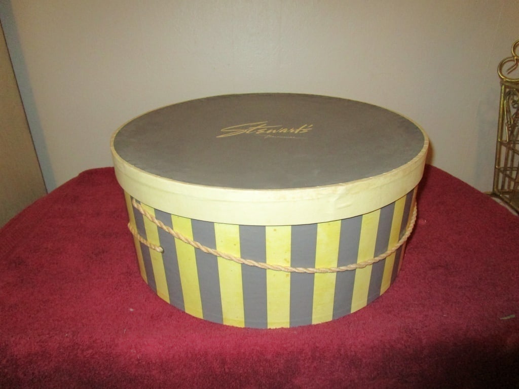1940s Hat Box, Stewarts Baltimore: 1940s Hat Box, Stewarts Baltimore. Lemon, green and gray strips. Original rope and tissue paper. Completely in tact. Some discoloration and staining due to age and use. Meas. 7:h x 16"r.