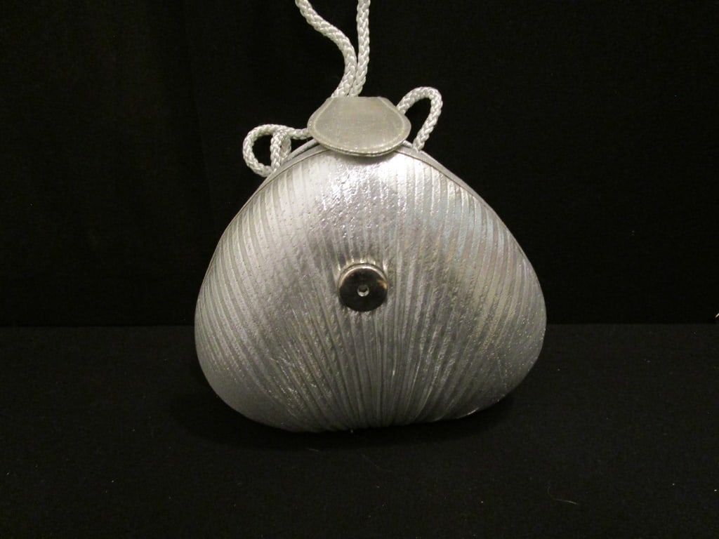 Vtg Silver Shell Shoulder / Evening Bag: Vtg Silver Shell Shoulder / Evening Bag with snap closure. Silver corded strap. Meas 6"w x 5 1/2"h x 2 1/2"d. Interior is black satin. Near mint condition.