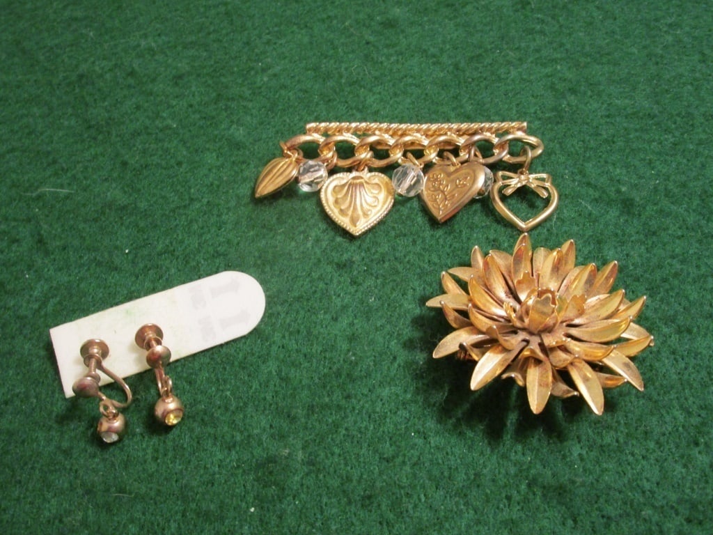 1950s GP Brooches and Earring Set: 1950s gold plated brooches and earring set. 3 pieces. Brooch has dangling hearts and beads, meas. 2 1/2"l x 1 1/2"h. Shasta daisy gold plated brooch meas 2"round. Gold plated w/ cubic zirconia screwba