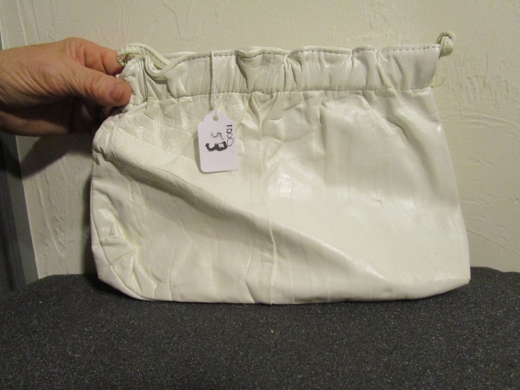 White Clutch Purse w/ Strap: White clutch purse w/ strap, clamshell hinged closure. Satin purple interior. Nice condition Meas. 8"h x 11"w, 20" strap.