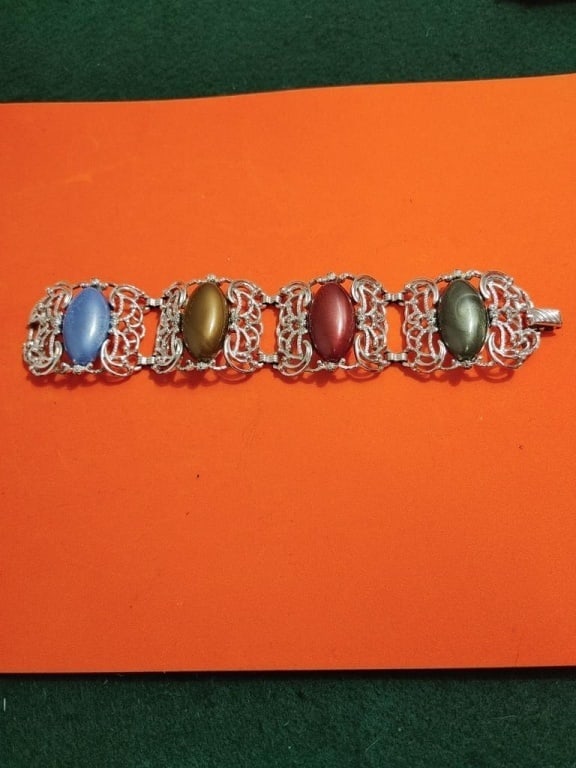 Vtg Sarah Coventry SP Bracelet: Vintage Sarah Coventry silver plated bracelet with varying colored large acrylic gemstones. open filigree design, very detailed. Meas 1 1/2"h x 3"w. when closed.