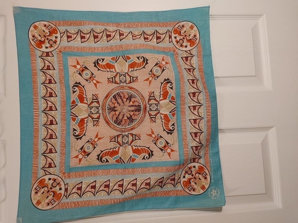 Vtg WamCraft Tribal Print Scarf: Vtg Tribal Print Scarf. 50% Cotton / 50% Polyester. Handcrafted USA. Tribal design, blue edge. Slight fray in one corner. WamCraft NA Meas. 20 1/2h x 22"w.