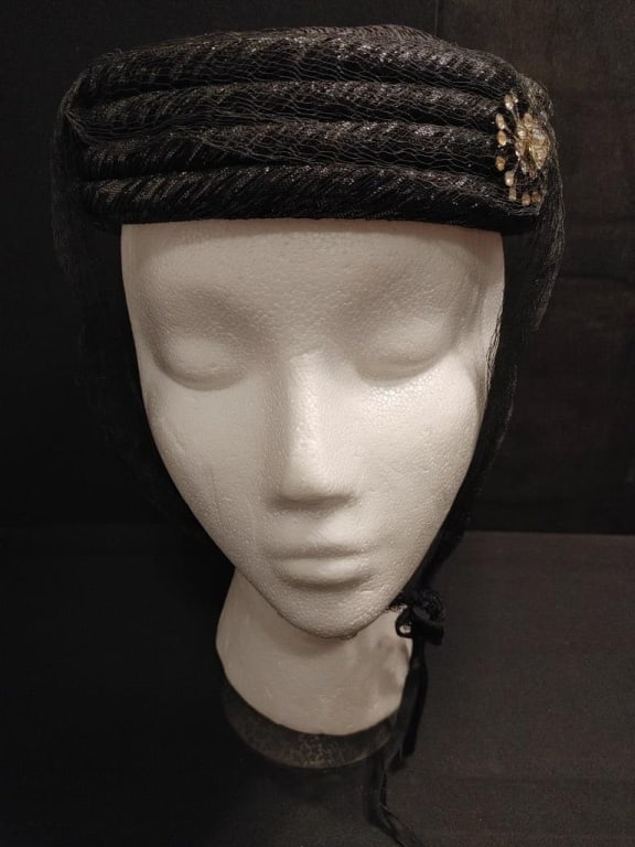 1940s Hess Bros. Allentown Hat Round Ribbed Black: 1940s Hess Bros. Allentown Hat Round Ribbed Black. Original label. Black ribbed bands, shimmer accents, w/ lace chin ties. Silverplate star burst medallion w/ rhinestones - in tact no missing stones. 