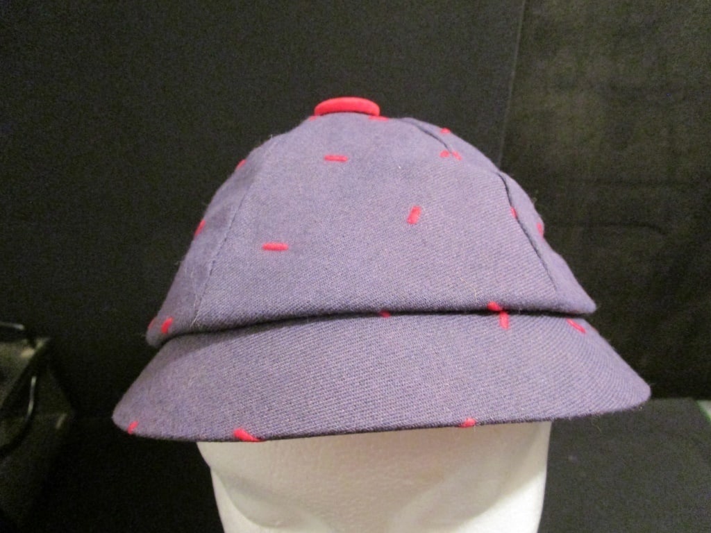 1960s Blue Beanie w/ Red Stitching: 1960s Blue Beanie w/ Red random stitching and top knob. Meas. 9 1/2" x 8" x 5 1/2". Mint condiion.