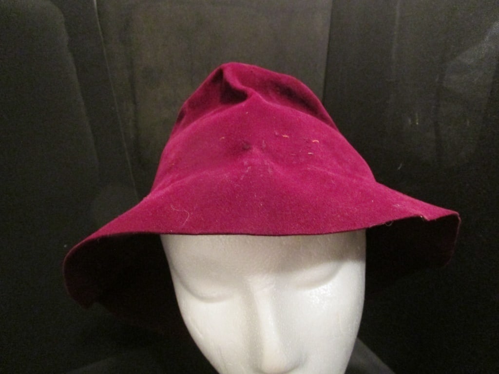 1960s Cranberry Velvet Hat w/ Elastic Chin Strap: 1960s Cranberry Velvet Hat w/ Elastic Chin Strap. Fedora style, collapsible, some markings, gathered for indented floppy effect. Very nice condition for age. Meas. 11 1/2r x 7"h.
