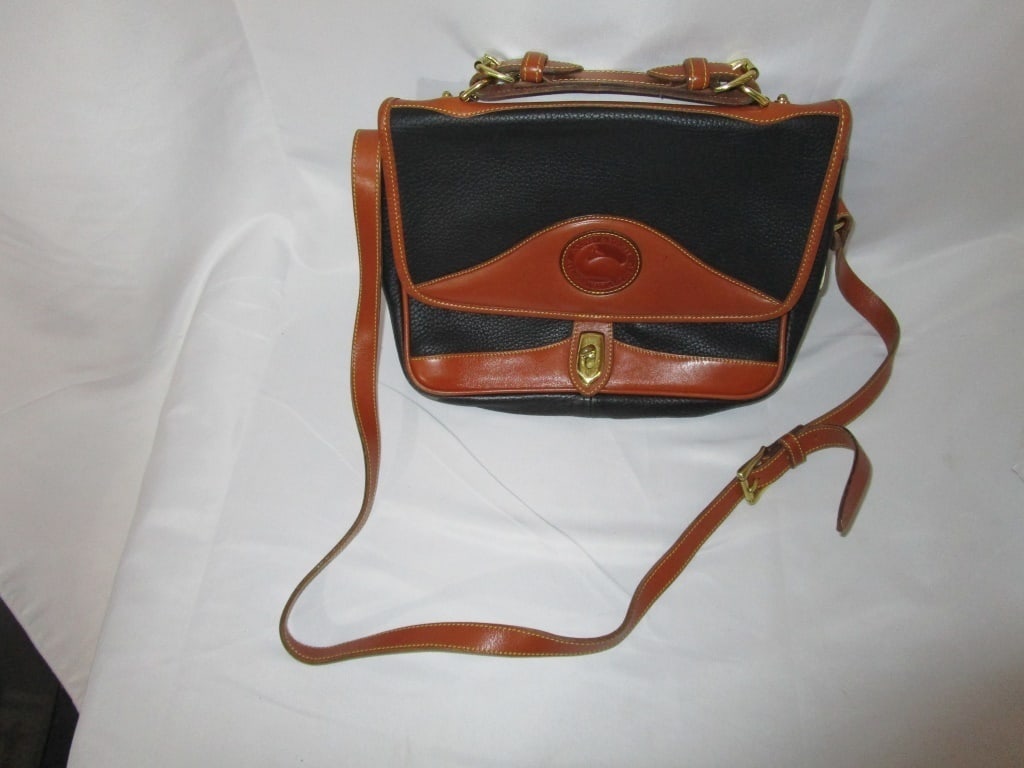 Vtg Dooney & Bourke Leather Signature Carrier Bag: Vtg Dooney & Bourke Leather Signature Carrier Bag / Satchel with brass accents, signature logo on front. Fold-over close with latch. All leather with interior leather zippered pocket and credit card s