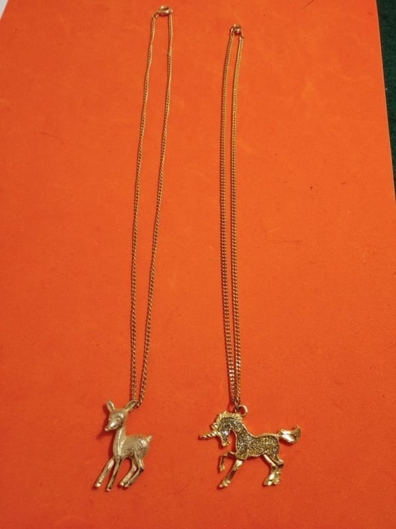 Deer/Fawn Necklace & Unicorn Necklace: Sterling silver chain w/ brass deer/fawn pendant. Necklace meas 8 1/2"l, Pendant meas 1 1/4"h x 3/4"w. Bedazzled unicorn pendant on gold plated chain. Chain meas 8"l, pendant meas. 1'h x 1 1/2"w.