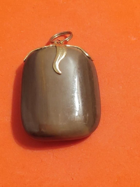 Brown Striped Agate Gemstone Pendant: Brown Striped Agate Gemstone Pendant w/ gold plated tendril setting. Meas 1 1/2"h x 1"w.