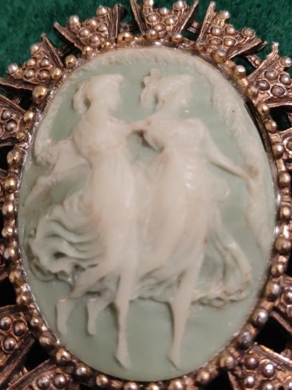 Antique Carved Jade-like Brooch / Pendant: Antique Carved Jade Brooch / Pendant. Detailed designed gold-tome oval frame w/ crown-like chevrons. Each chevron has 6 balls w/ separators on each side. There are no balls missing. whimsical design o