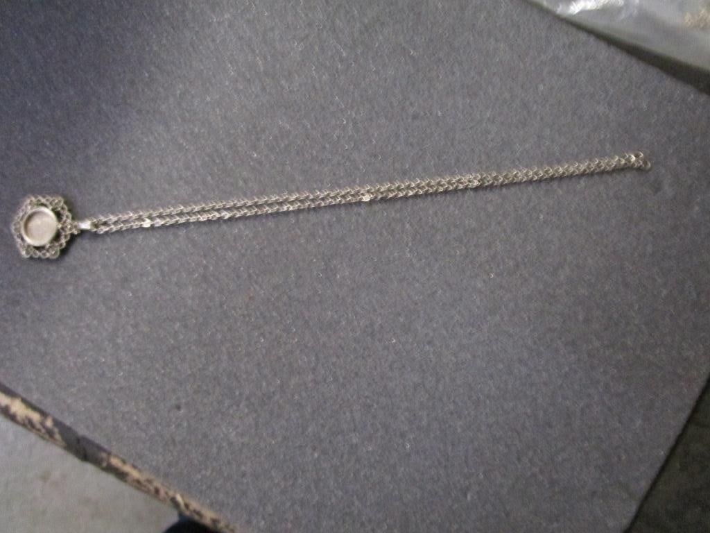 1973 Roosevelt Dime Pendant w/ SP Chain: 1973 Roosevelt Dime Pendant w/ silverplated chain. Dime on pendant wi filigree design surround. Chain plus pendant meas. 13.5"l. Very nice condition.