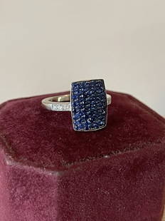 Postage Stamp Designed Sapphire and Diamond Ring: 14k White gold. 53 Round Faceted Blue Sapphires 1.80cts. 16 full cut diamonds 0.12cts. Ring weighs 6.00 grams.Finger size 8 1/2. 16.40 mm wide **Shipping on this item offered through, UPS (843)