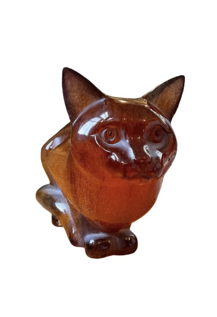 Daum Crystal Crouching Amber Cat: Daum amber cat sculpture made using the â€œPate de Vera” glassmaking technique. Handmade in France. It is signed â€œDaum France”. Measures 5 1/2 inches wide, 11 inches long, and 7