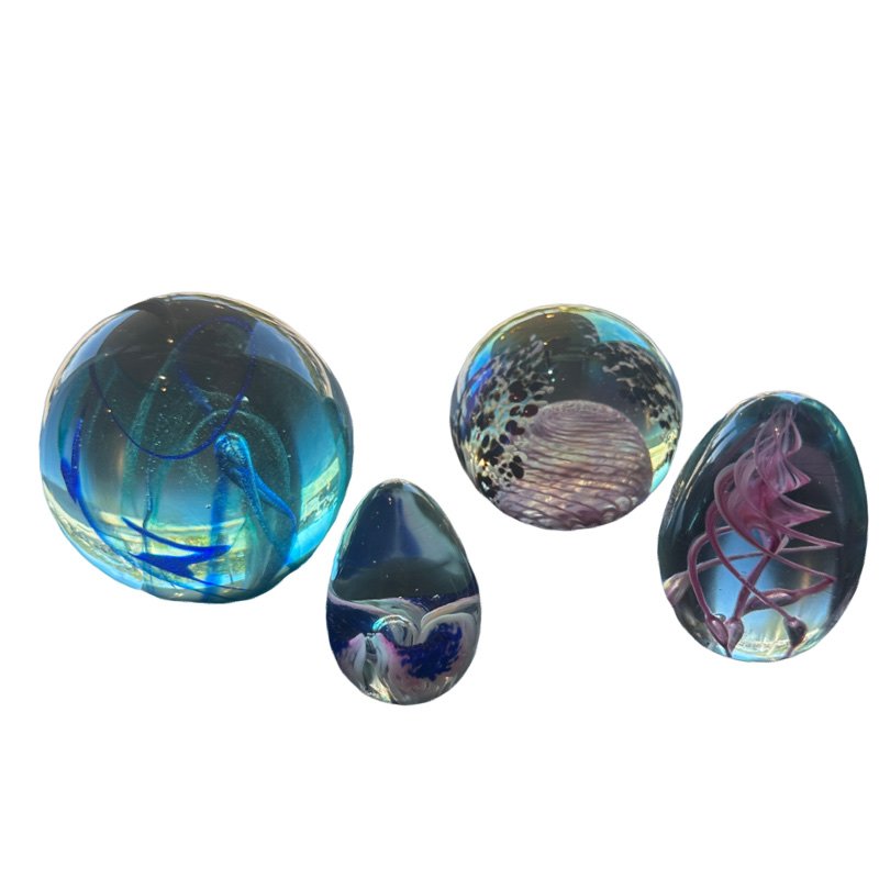 Lot Of Two OBG (Ornamental Blown Glass) and Two MSH (Mount St. Helen) Paperweights: This lot includes four beautiful paperweights all signed there are two OBG paperweights egg shaped one dated 1988 :6 1/4 circumference 3"H round blue one dated 1992:10 3/4" circumference 3 3/4"H two M