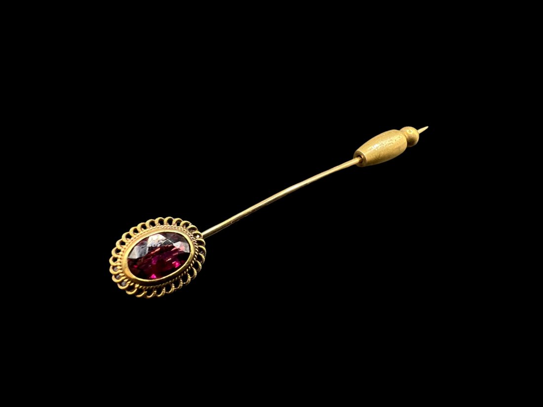 Vintage 14kt Gold Amethyst or Garnet Stick Pin: Vintage 14kt Gold Amethyst or Garnet Stick Pin. Beautiful filigree detailing around purple amethyst stone. Marked with "14kt" and eye stamp. Measures 2 3/4" long. Stone with filagree measures 10.31 mm