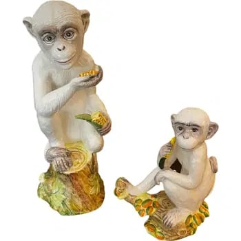 Pair Of Chelsea House Monkeys: Pair of fun monkeys eating corn. One is marked Chelsea House. Measurements of larger monkey: 17.75”H x 6.75”L x 7.25”D Measurements of smaller monkey: 11”H x 9”L x 6&rdqu