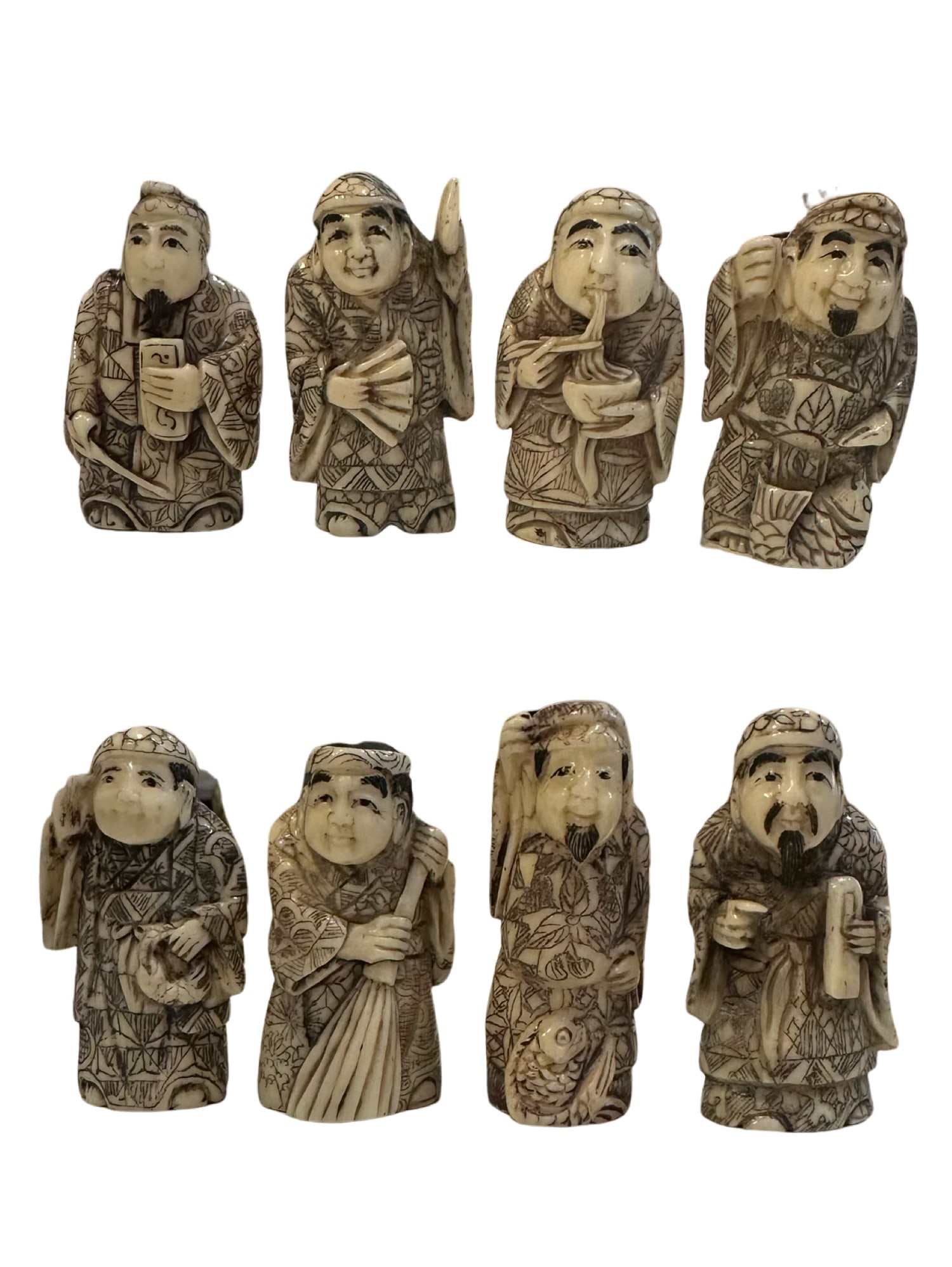 Eight signed JAPANESE CARVED BONE?? NETSUKE: eight JAPANESE CARVED BONE?? NETSUKE The earliest netsuke were made from wood, gourd, or tree root bone became the most common material in the 18th century