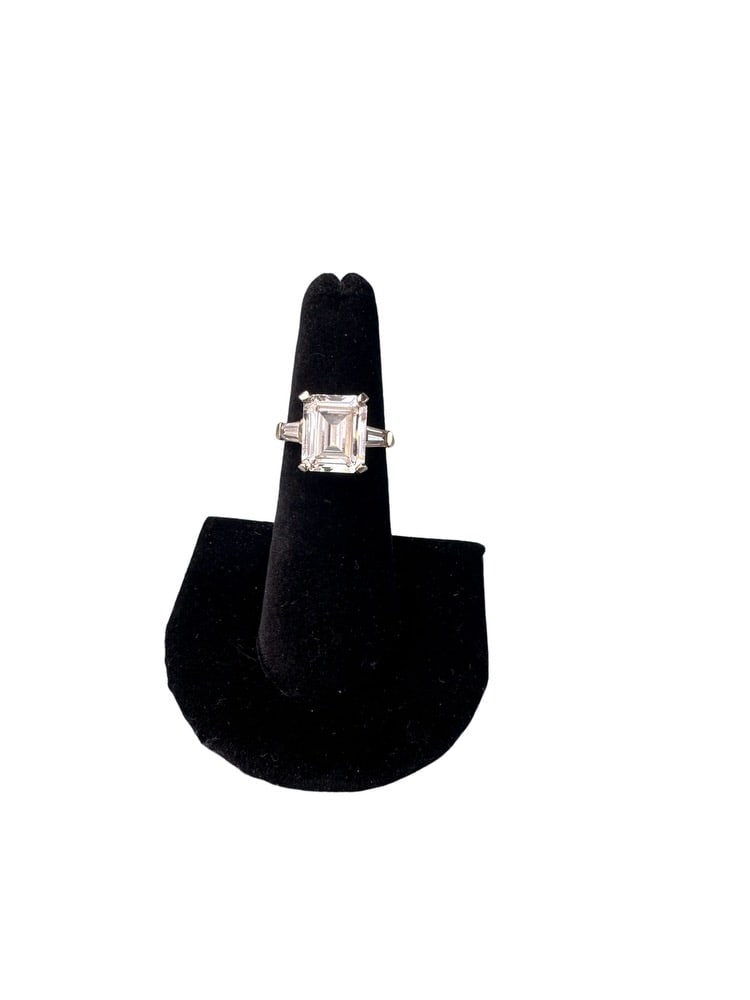 Ladies 14K White Gold Engagement Ring: Ladies 14K White Gold Engagement Ring containing a center 4-prong set 11mm by 5.1mm cubic zirconia and a side tapered baguette cubic zirconia. These are in the 5.5 by 3.1mm range and one has a chip on