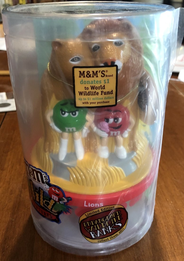 Lion King: M & M bank, has protective film, no bag of M&M's, see photos.