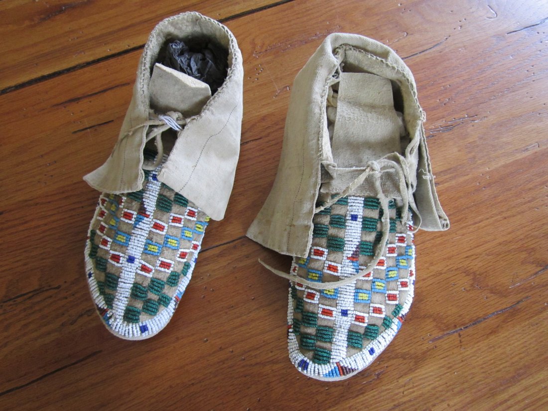 Sioux Plains Leather and Canvas Beaded Moccasins: Beaded moccasins, sinew sewn and thread sewn. Leather hide moccasins with canvas flaps / vamps. 10.5 inches long. Has small squares of open and beaded designs on tops, various colors. circa. 1890. [ i