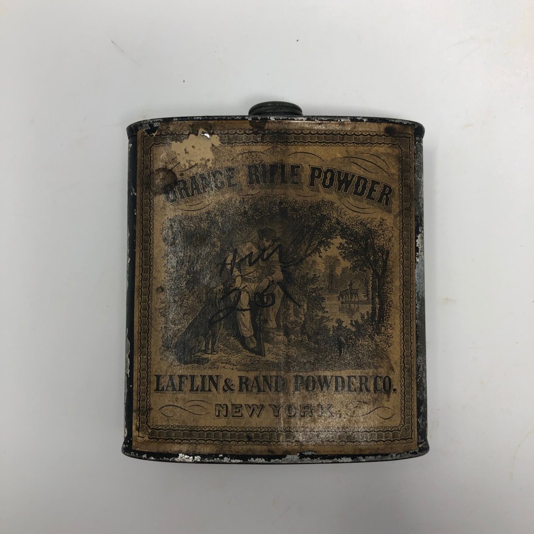 Tin Rifle Powder Can. (M579): Metal Black-Powder Gun Powder Can, with its cap and label, printed ORANGE RIFLE POWDER, LAFLIN & RAND POWDER CO., New York. 4.25 inches tall x 3.75 inches wide x 1.25 inches. [ Third party shipping-se