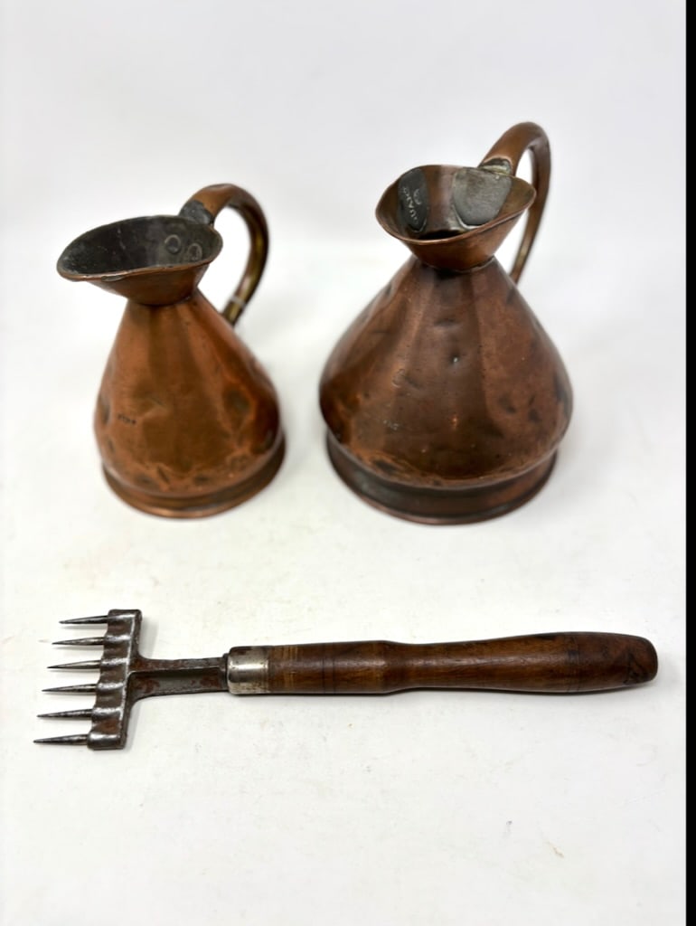 Metal Primitive Items: Three (3) metal primitive items including two copper measures. The copper measures are of 1 Pint and 1 Quart, as stamped. Both measures are in the shape of handled pitchers with flat bases. The pint