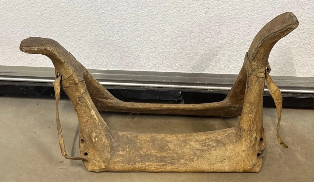 Rawhide Indian Saddle: Here is a rawhide Native American Saddle, probably a Blackfoot Indian woman's saddle. Is 21" x 10" x 11" high. circa. 1860. Shipping for this item is to use 3rd party shipping. I-1065
