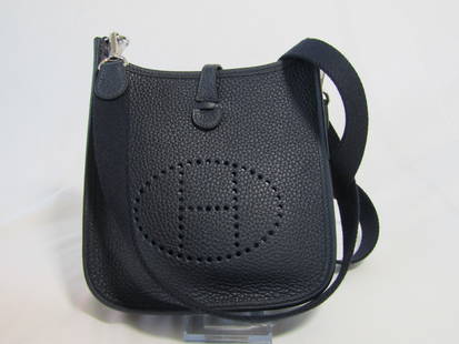 Hermes Evelyne TPM Bleu Nuit: This bag is in excellent condition. Any scuffing is not noticeable. The interior is clean and the bag has no odors. INCLUSIONS Box, Dust Bag, Strap Purchase of this bag includes an Entrupy Certificat