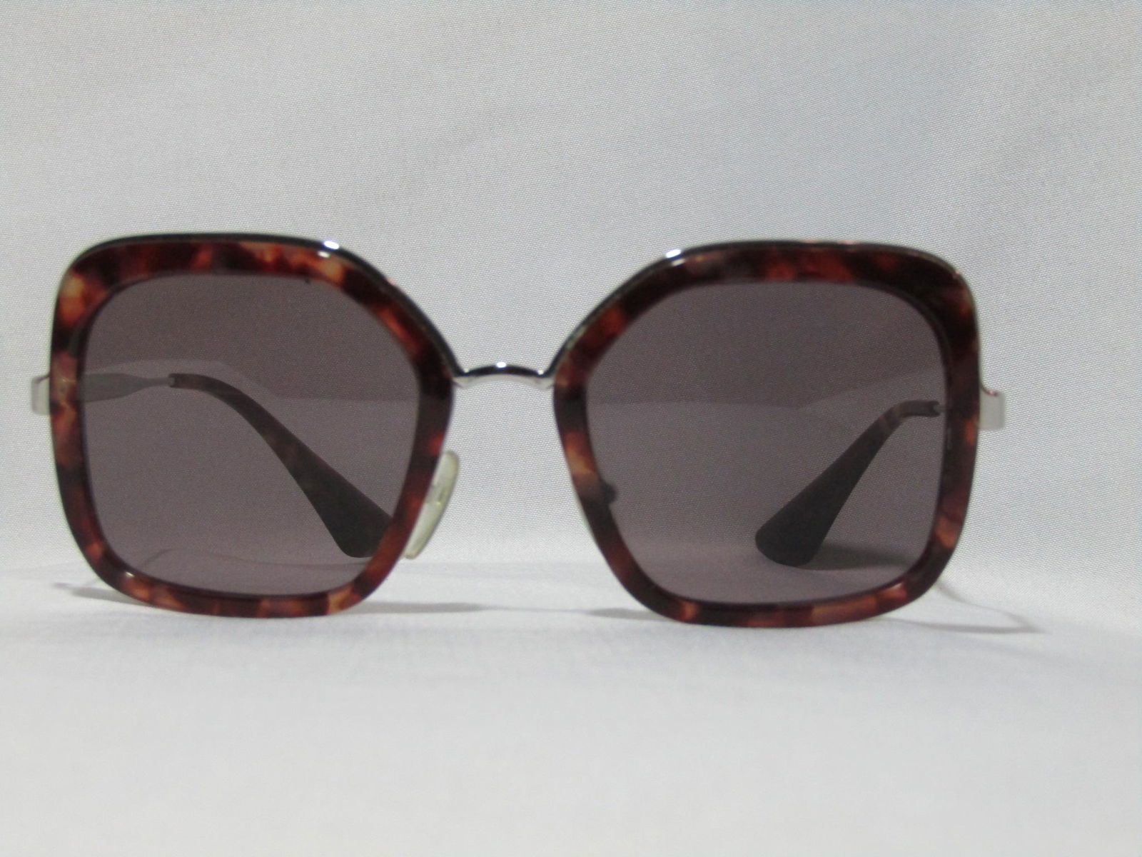 Prada Tortoiseshell Cinema Sunglasses: These sunglasses are in excellent condition. There are no noticable scratches on the lenses. INCLUSIONS Box CONDITION EXPLANATION A+ - Like New. No identified blemishes. A - Excellent Condition