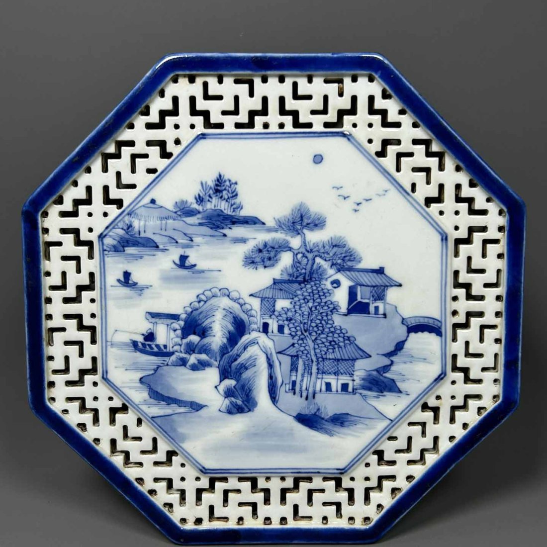 A blue and white landscape octagonal hollow tea table made in the Kangxi reign of the Qing Dynasty: A blue and white landscape octagonal hollow tea table made in the Kangxi reign of the Qing Dynasty
