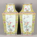 A pair of Qianlong enamel and gold-painted square vases with windows and seasonal floral patterns.