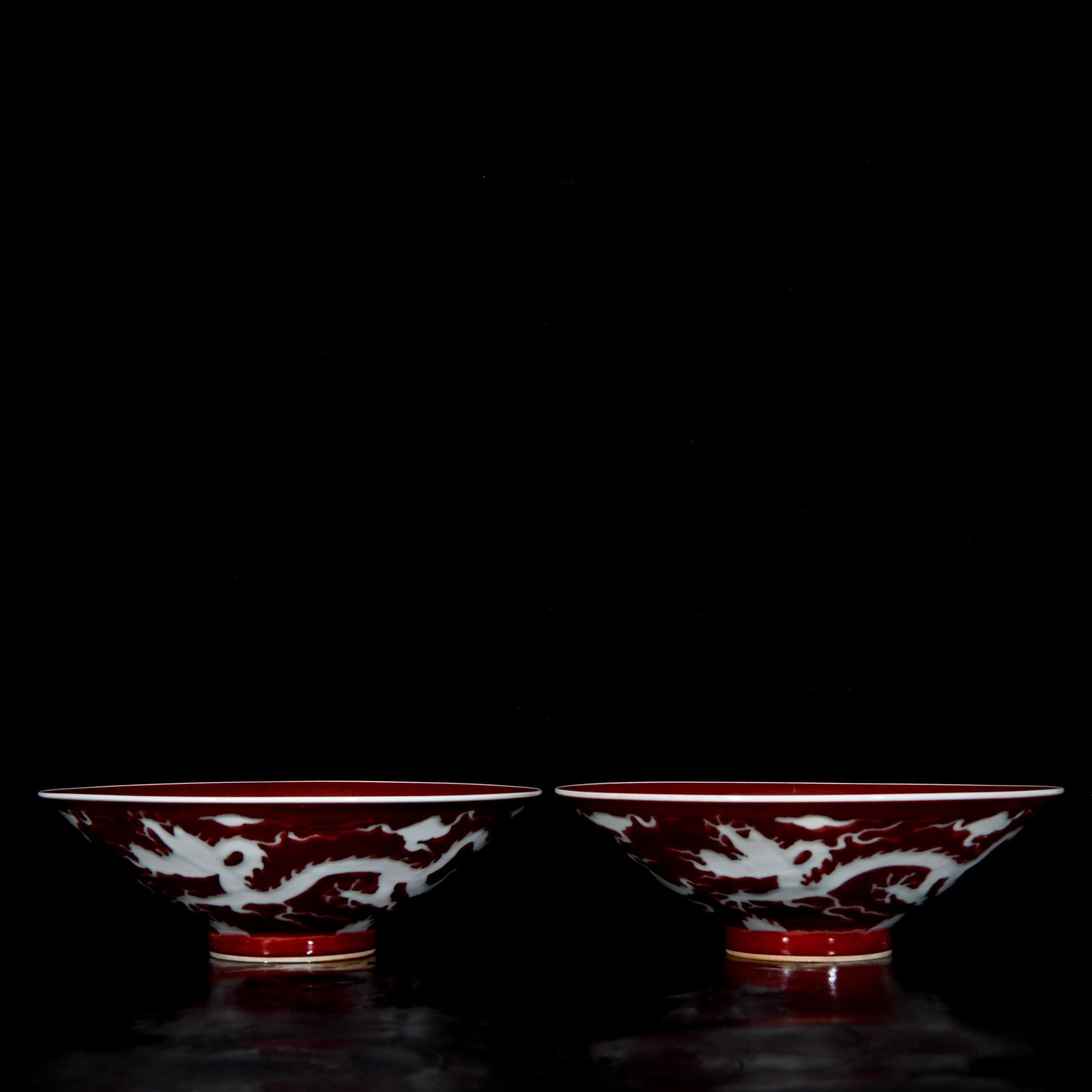 A pair of Ming Xuande style red glaze leaf bowls with white carving dragon pattern: A pair of Ming Xuande-style celadon glaze white-carved dragon pattern conical bowls, 7.5x23.3 cm