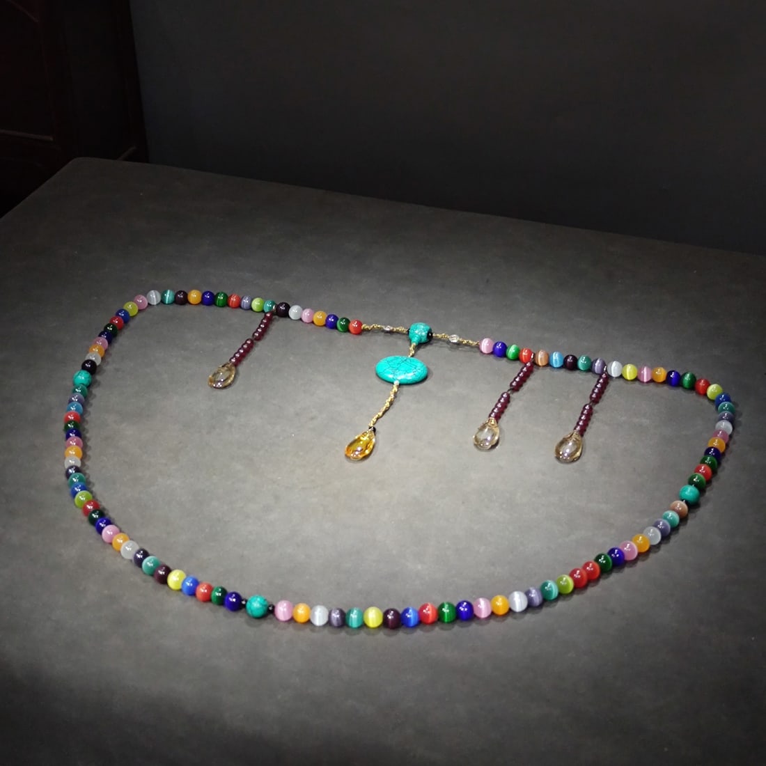 A set of colorful cat's eye court beads from the Qing dynasty palace: A set of colorful cat's eye court beads from the Qing Palace, bead diameter 1.4 centimeters, circumference 150 centimeters, weight 460 grams. Accessorized with turquoise, natural crystal pendant, and