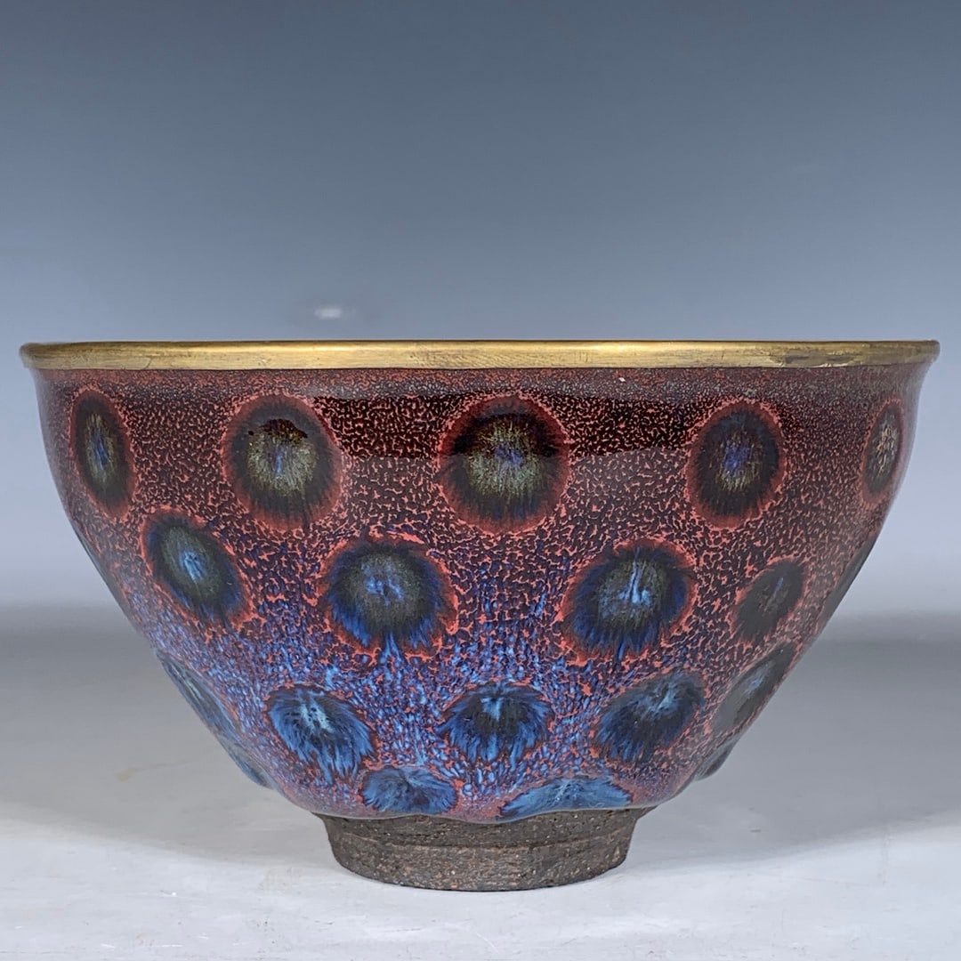 Jian kiln tea bowl with gold rim and oil spot glaze.: Jian kiln cup with gold-wrapped mouth, 7.5 cm in height, 12.5 cm in diameter.