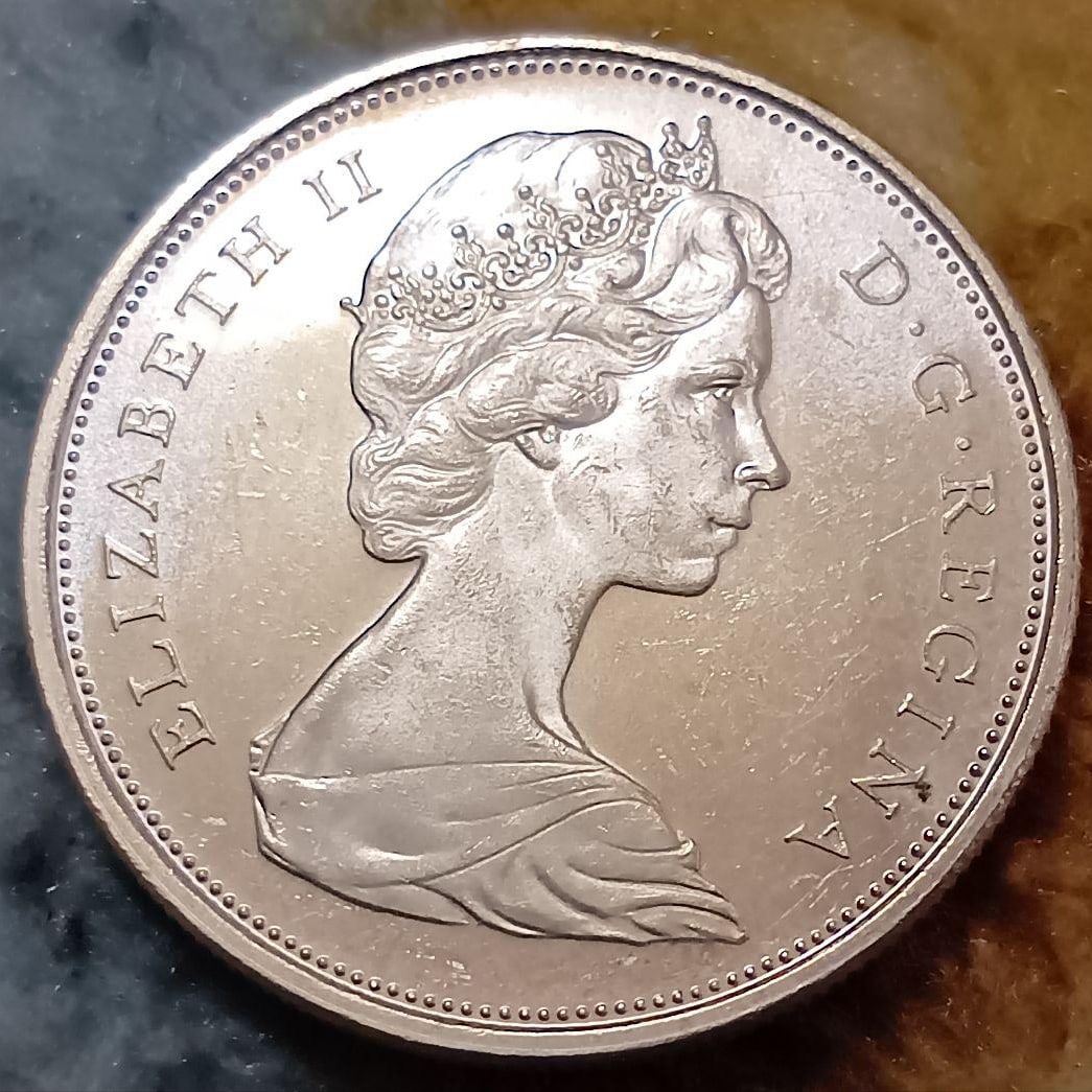 1966 Canadian 50-cent silver coin and 1965 Canadian 10-cent silver coin. (1 of 4)