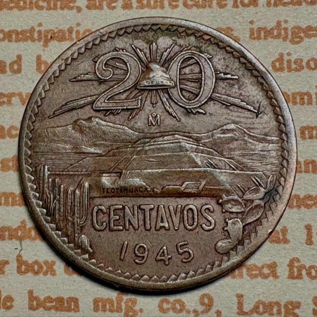 Mexican 20 centavos coin, 1945: Country of issue: Mexico Denomination: 20 cents Year: 1945 Mint mark: Mo (Mexico City Mint) Features: Depicts the Teotihuacan Pyramid.