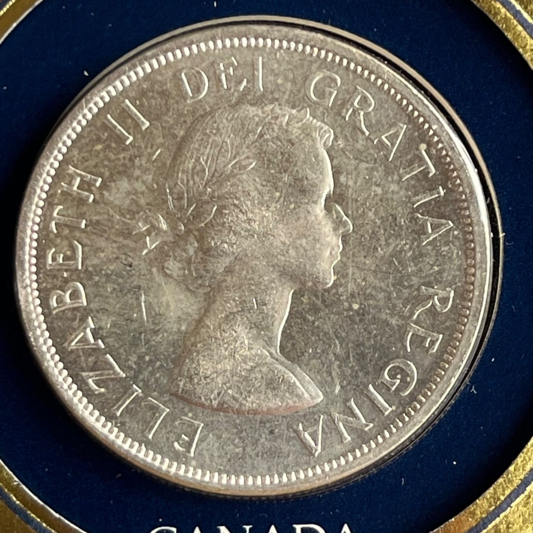 Guaranteed genuine 1963 Canadian 1 dollar silver coin.: Country: Canada Denomination: 1 dollar Year: 1963 Material: Silver (purity .800) Weight: Approximately 23.3 grams Diameter: Approximately 36 millimeters Design (obverse): Portrait of Queen Elizabeth I