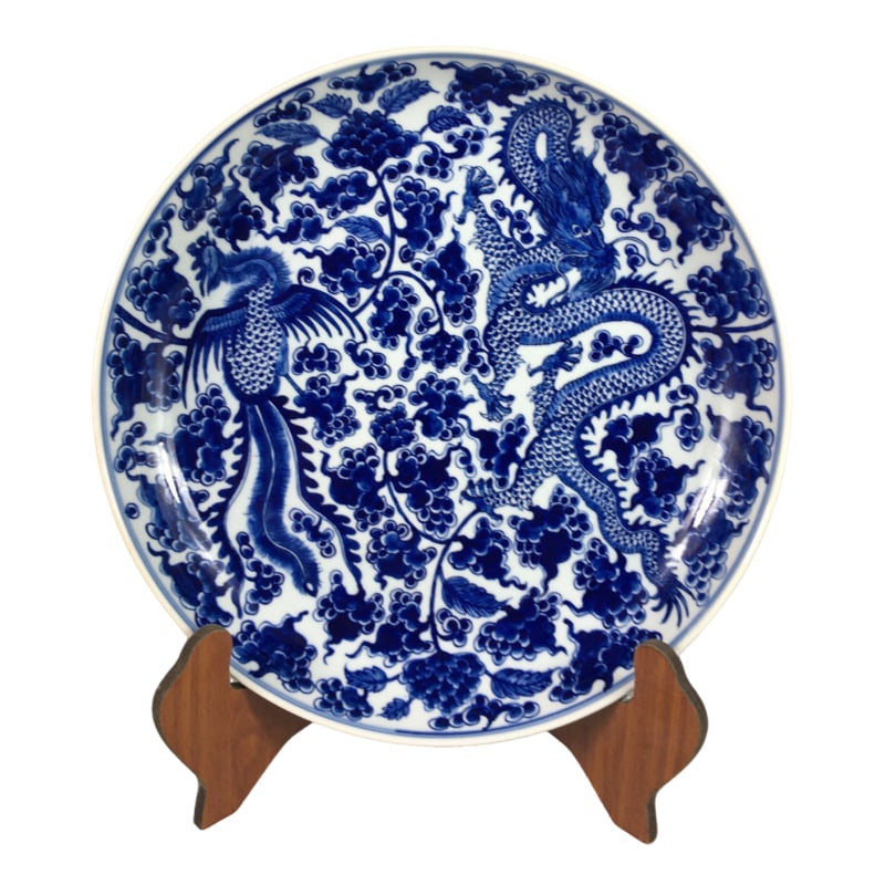 Hand-painted blue and white porcelain plate with intertwined lotus, dragon, and phoenix patterns. (1 of 10)