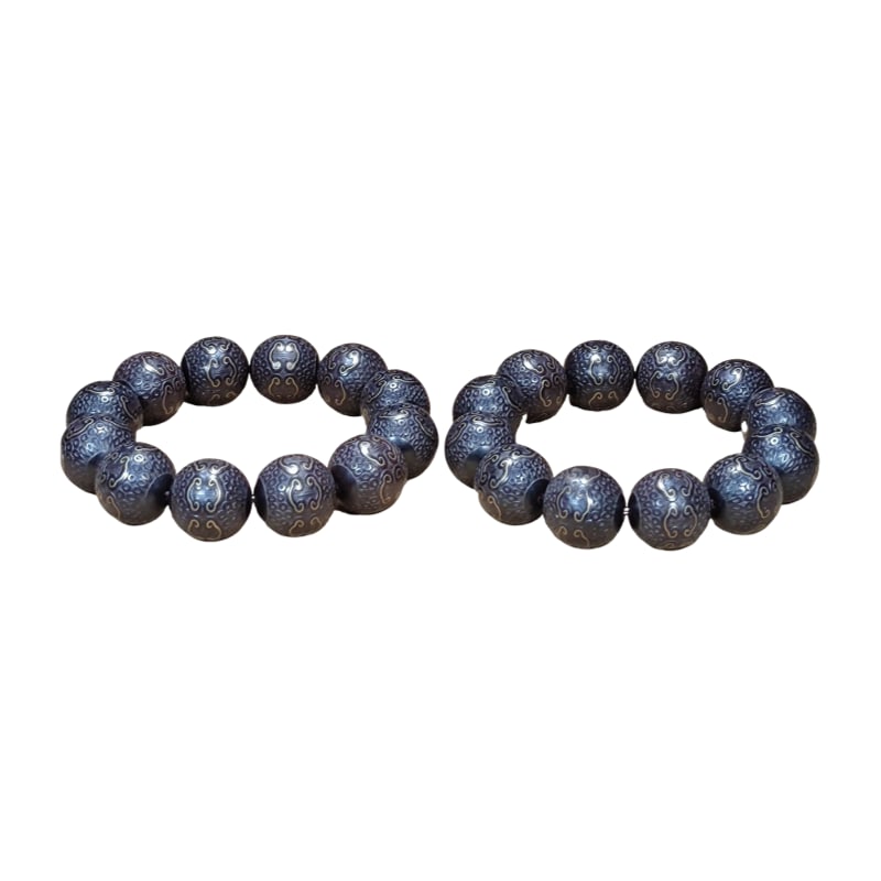 A pair of agarwood bracelets inlaid with gold wire. (1 of 10)