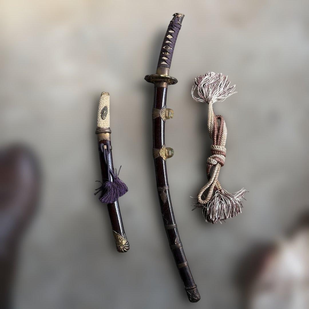 Japanese sword, accompanied by metal fittings and purple tassel.: Japanese sword, accompanied by metal fittings and purple tassels.