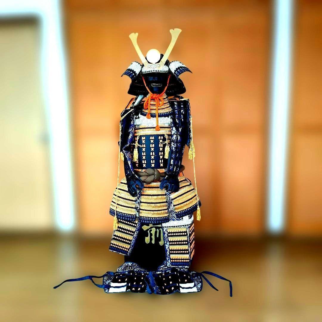 Traditional Japanese armor and helmet, life-sized, with orange-edged black cuirass.: This piece appears to be the work of Kagoshima Prefecture's traditional artisan, Kendo Keiko, or possibly from the Marutake Workshop. The style is very similar, suggesting that he may have trained at 