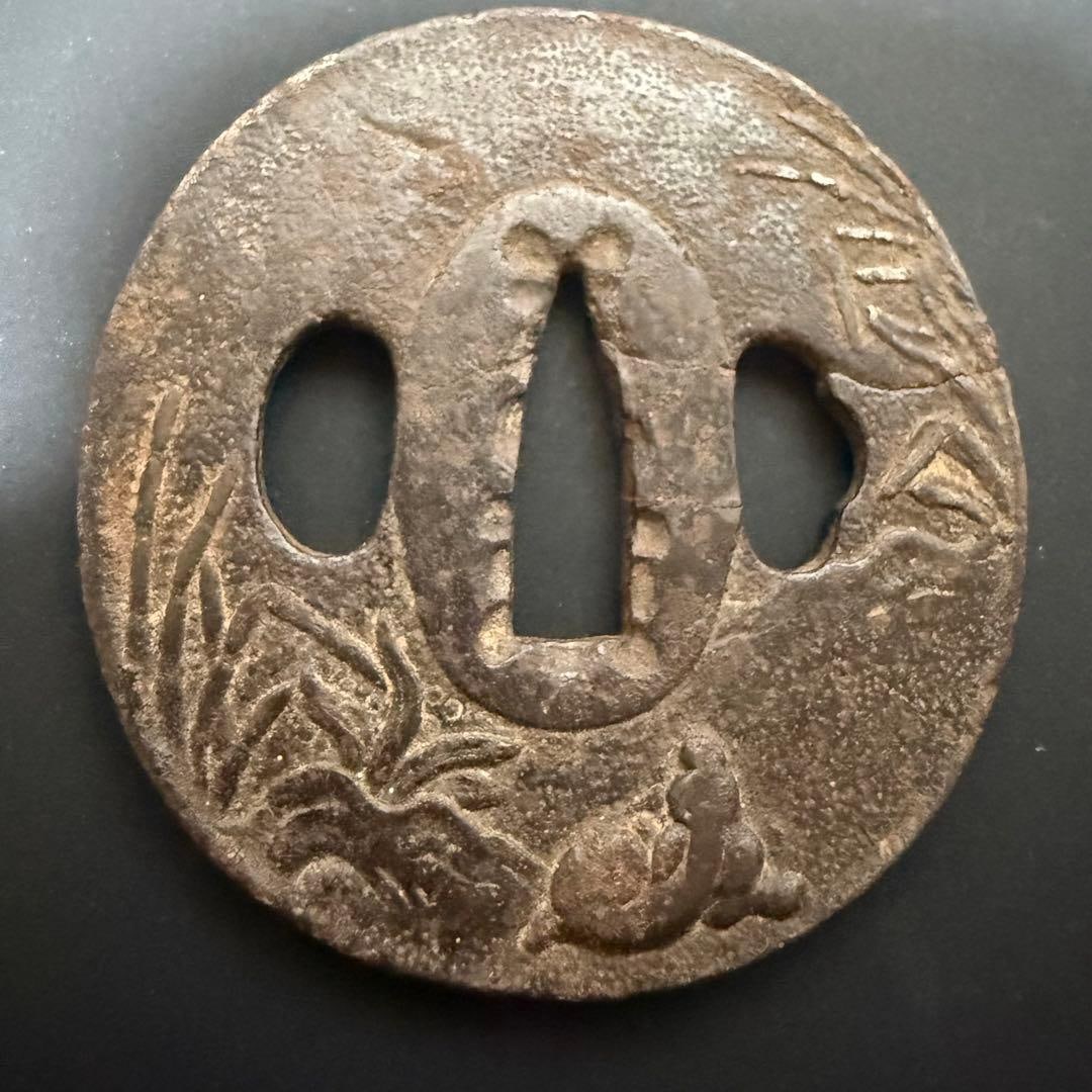 An antique sword guard from before the Edo period.: A pre-Edo period antique sword guard. It possesses a distinct Japanese style, exuding a captivating traditional charm. Please refer to the images for dimensions. As it is an antique, there may be some